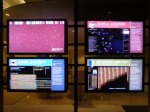 Four monitors facing the street highlight research areas